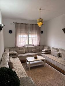 a living room with a couch and a table at Fès comfort stay in Fez