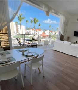 a living room with a white table and chairs at Beach Veranda Hotel Punta Cana in Punta Cana