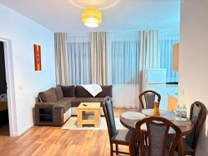 a living room with a couch and a table at EBRAM II Apartments Görlitz in Görlitz