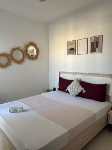 a bedroom with a large bed with two mirrors on the wall at Fès comfort stay in Fez