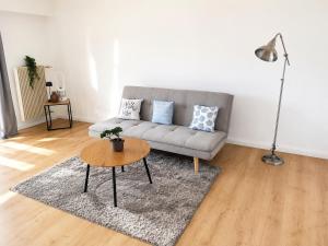 a living room with a couch and a table at Bright Lake-View Apartment in Montreux