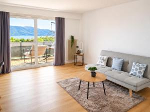 a living room with a couch and a table at Bright Lake-View Apartment in Montreux