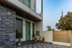 a house with a green door and a fence at Velmora Stay Premium Luxury Villa with Private Pool in Amritsar