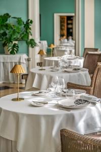a group of tables with white table cloths on them at Le Château d'Etoges - Champagne in Étoges