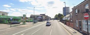 a car is driving down a city street at Coventry Escape in Longford