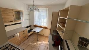 a small kitchen with a table and a chair in it at Nice Studio Apartment in Gumpoldskirchen
