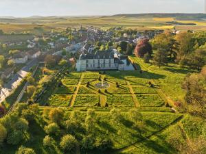 an aerial view of a large house on a green field at Le Château d'Etoges - Champagne in Étoges