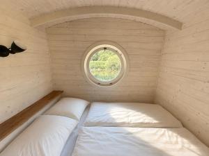 a small room with two beds and a window at maringotka Hedvika glamping in Pašice