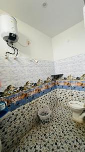 a bathroom with a toilet and a camera on the wall at Radha krishna in Vellore