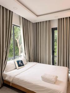 a bedroom with a bed and a large window at Mango Villa Long Hải Beach in Long Hai +83 photos