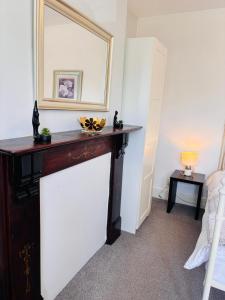 a room with a table with a bowl of fruit on it at Private Ensuite Room with Bay Window, Free Parking and Fast WiFi in Sheffield