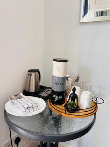 a table with a coffee maker and other items on it at Private Ensuite Room with Bay Window, Free Parking and Fast WiFi in Sheffield +4 photos