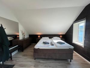 a bedroom with a large bed in a attic at Jolster SPA apartments for 2 in Skei