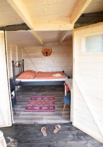 a bedroom with a bed in a wooden house at Cottage in Remízek in Havlíčkŭv Brod +10 photos