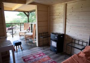a room with a stove in a wooden cabin at Cottage in Remízek in Havlíčkŭv Brod