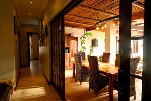 a dining room with a wooden table and chairs at Skilpadvlei Cottage and Studio's in Velddrif