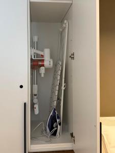 a room with a closet with a rack of tools at AC Central Station apartments in Daugavpils +11 photos