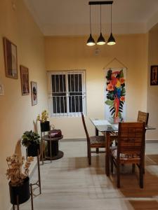 a dining room with a table and chairs and a window at Mong Mao Manor in Guwahati