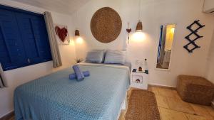 a bedroom with a blue bed in a room at Pousada Casa Azul do Piauí in Luis Correia +46 photos