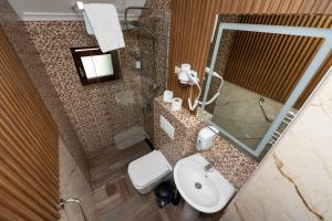 a bathroom with a toilet and a sink and a mirror at Rooms and apartmants Mirovic in Kolašin +63 photos