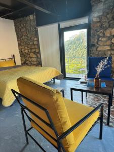 a bedroom with a bed and a chair and a table at Fannoun Getaway Lodge by Hansa in Ḩayy al Qal‘ah