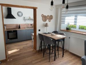 a kitchen with a table and chairs in a room at Au fil de la Semois in Bohan