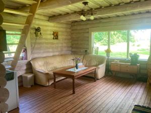 a living room with a couch and a coffee table at Kenu Saunamaja in Haapsalu +4 photos