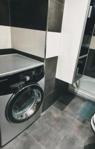 a washing machine in a bathroom with at Apartman Brzović in Omiš +9 photos