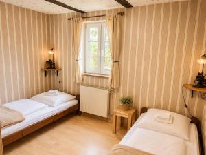 two beds in a room with a window at Alte Faktorei Schierke in Schierke
