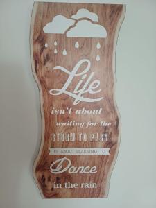 a wooden sign with dance in the rain at M&L Hartberg in Hartberg