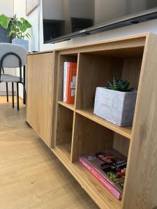a book shelf with books and a tv on top at Apartament Mini Stary Sącz in Stary Sącz