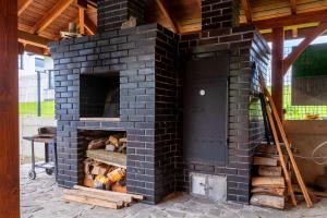 a brick oven with logs inside of it at Lipove Spa in Lipowe