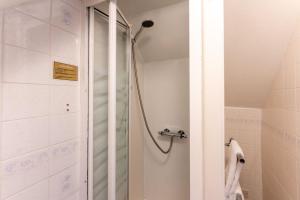 a shower with a glass door in a bathroom at Cransley in Bournemouth +113 photos
