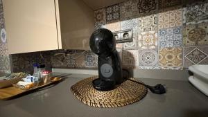 a black blender sitting on a counter in a kitchen at Alojamientos Templete in Caravaca de la Cruz +18 photos