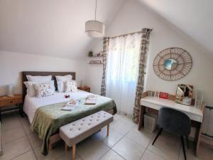 a bedroom with a bed and a desk and a chair at Celies Country Cottage in Blaru +33 photos