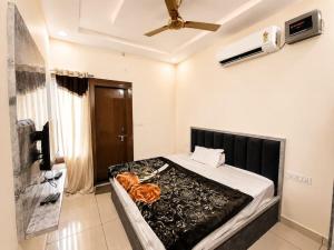 a bedroom with a large bed with a fan at HotelTree in Hisār
