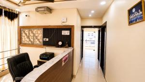 a waiting room with a desk and a chair at HotelTree in Hisār