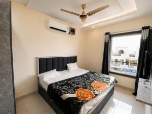 a bedroom with a bed with orange roses on it at HotelTree in Hisār