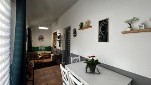 a hallway with a white table and a dining room at Gite du Tacot 21 in Saulieu