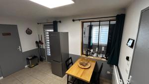 a small kitchen with a table and a window at Gite du Tacot 21 in Saulieu +3 photos