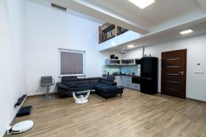 a living room with a couch and a table at Lipove Spa in Lipowe +2 photos