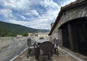 a table and chairs on the balcony of a building at Casa Rural GABARDA in Aso de Sobremonte