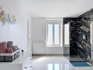 a bathroom with white walls and a glass door at EM LIFE COLMAR in Colmar