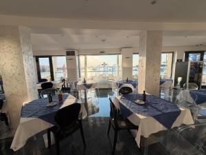 a restaurant with tables and chairs in a room at Water's Edge Hotel in Birżebbuġa +33 photos