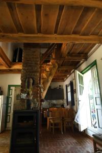 a kitchen and dining room with wooden ceilings and a stove at Jurina Hiža in Beletinec