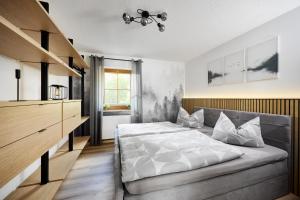 a bedroom with a large bed and a kitchen at Ferienwohnung Nähe Dresden mit Pool & Spielplatz - FeWo "Waldblick" und "Gartenblick" an der Talsperre Malter in Dippoldiswalde +36 photos