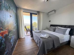a bedroom with a large bed and a balcony at Villa Dobric Apartments in Kavač +52 photos