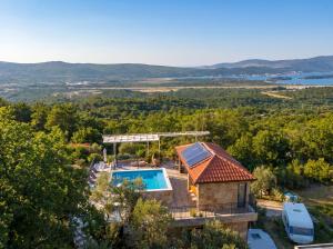 an aerial view of a house with a swimming pool at Villa Dobric Apartments in Kavač