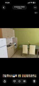 a kitchen with a table and two chairs and a table at Hotel Olivia in Agiokampos