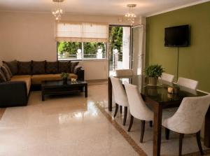 a living room with a table and a couch at Hotel Olivia in Agiokampos